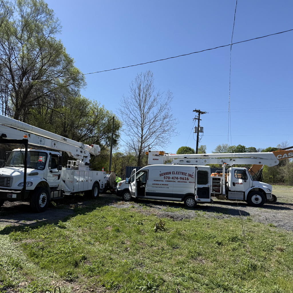 Herron electric work trucks at jobsite