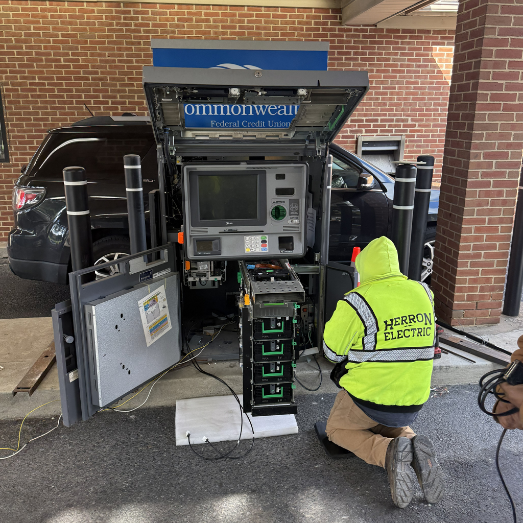 electrician working on bank atm machine